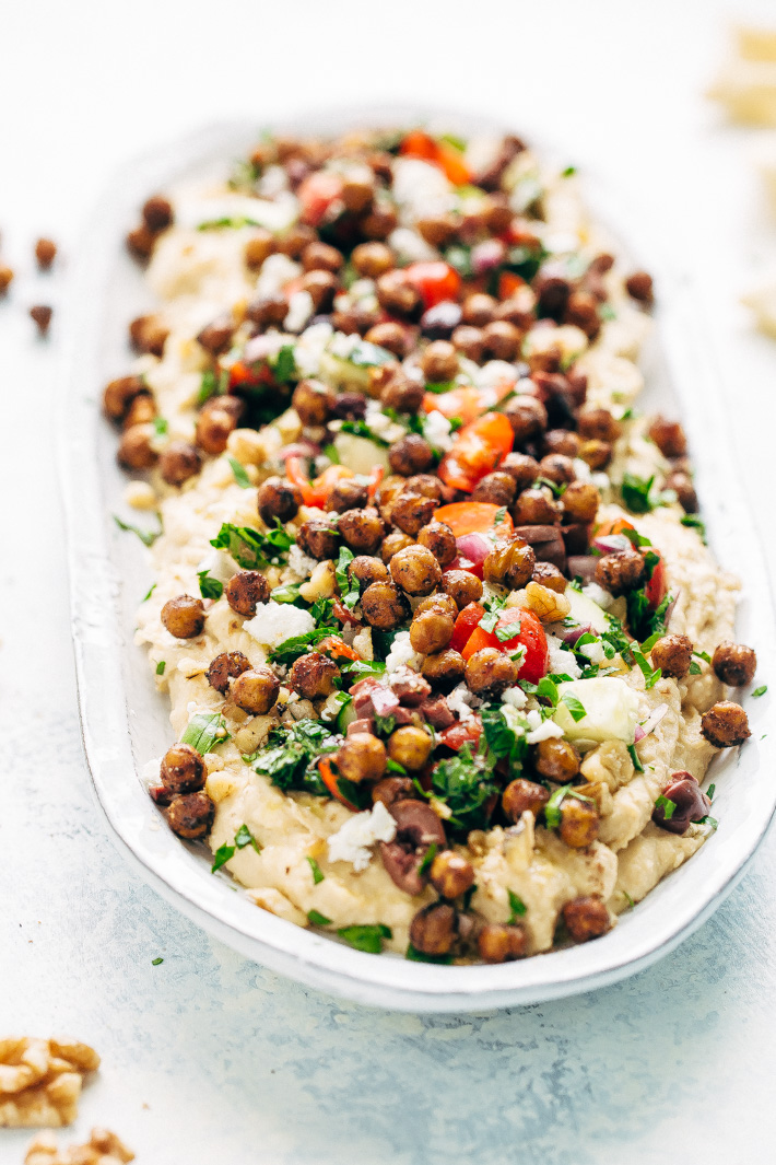 Seven Layer Chickpea Shawarma Dip - Smooth hummus topped with a parsley salad, salty feta, crunchy roasted chickpeas, and so much more! #7layerdip #sevenlayerdip #shawarma #shawarmadip #roastedchickpeas #sponsored by @californiawalnuts | Litttlespicejar.com