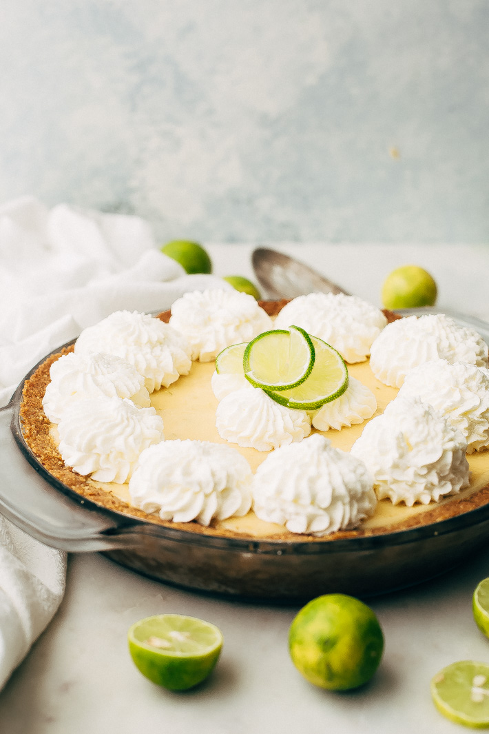 Summertime Key Lime Pie - A completely homemade sweet and tart key lime pie with the most delicious graham cracker crust! This pie is perfect to take to all your summer gatherings! #keylimepie #grahamcrackercrust #pie #4thofjuly | Littlespicejar.com