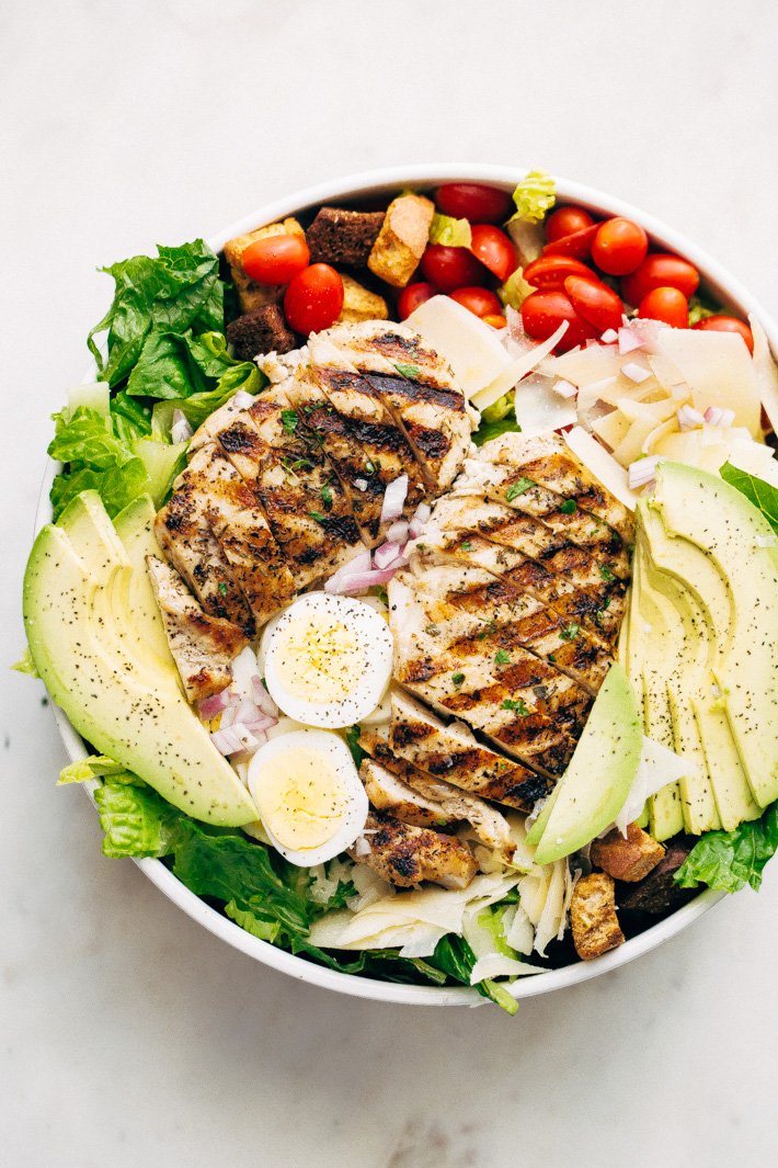 Grilled Romaine Chicken Caesar Cobb Salad - This salad combines all the things you love about a Cobb salad and all the things you love about a caesar salad! We're grilling the chicken and the romaine for more added flavor! #caesarsalad #caesarcobbsalad #cobbsalad #salad | LIttlespicejar.com