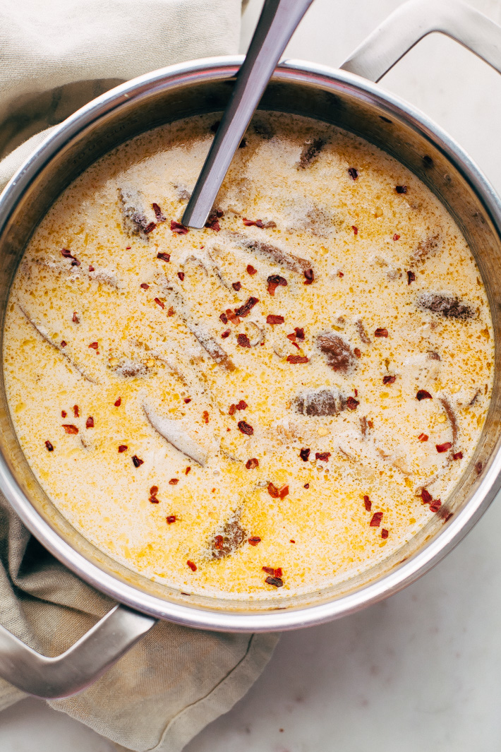 Creamy Comforting Chicken Coconut Noodle Soup - A Tom Kha Gai soup meets an American classic - chicken noodle. This soup is rich and comforting! #tomkhagai #thaisoup #coconutnoodlesoup #chickennoodlesoup | Littlespicejar.com