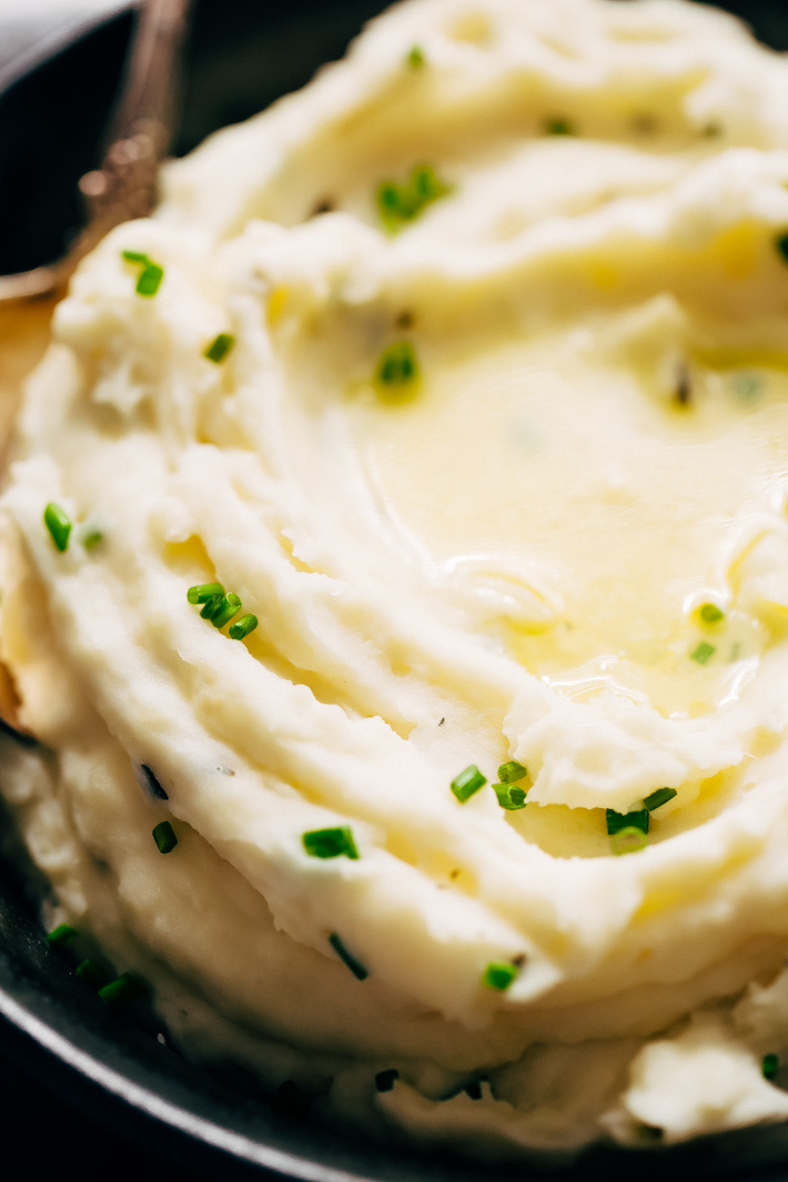 close up of fluffy mashed potatoes with chives on top