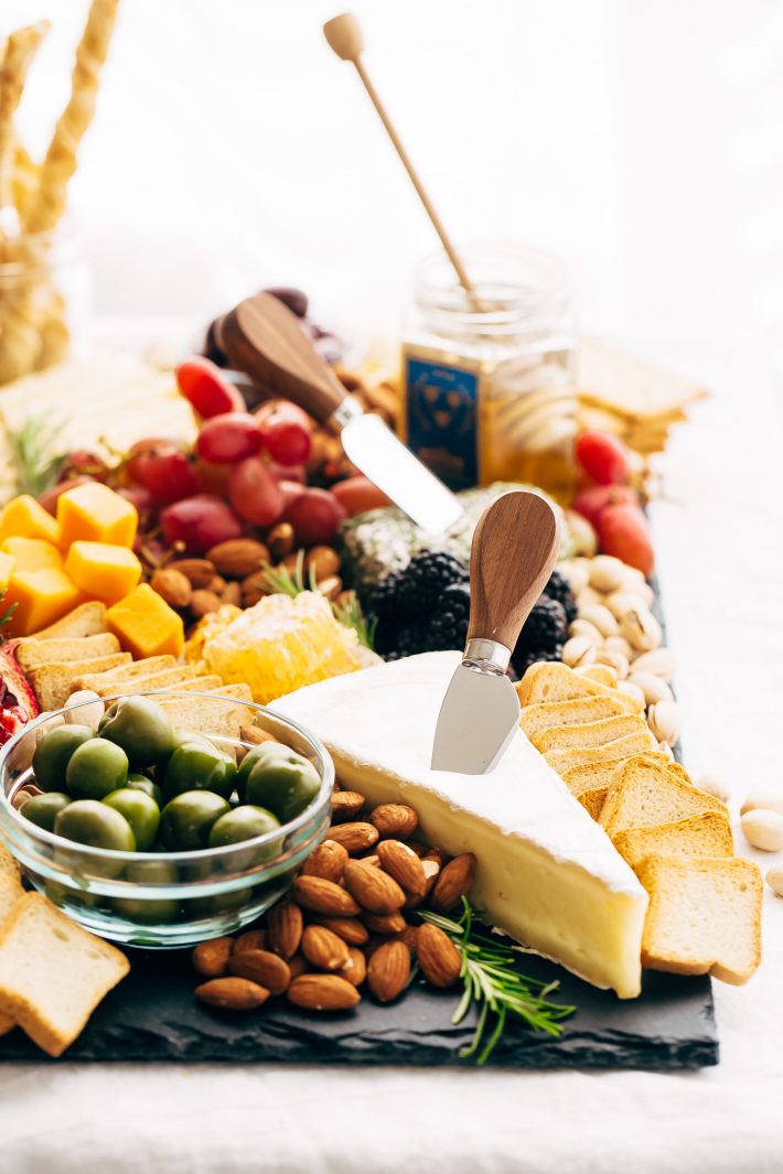 How to make an EPIC Holiday Cheese Board - Learn step-by-step how to put together the best cheese board your guests have seen! #holidaycheeseboard #cheeseboard #cheeseplatter #cheeseplate #cheeseandfruitplate | Littlespicejar.com