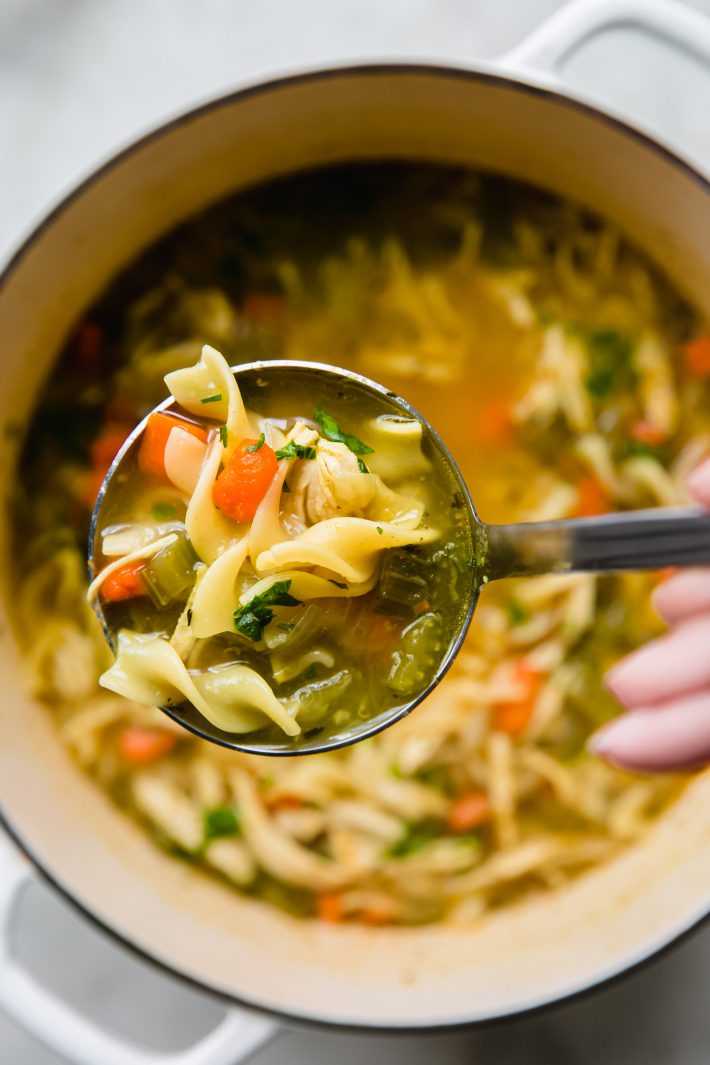 ladle of soup over soup pot