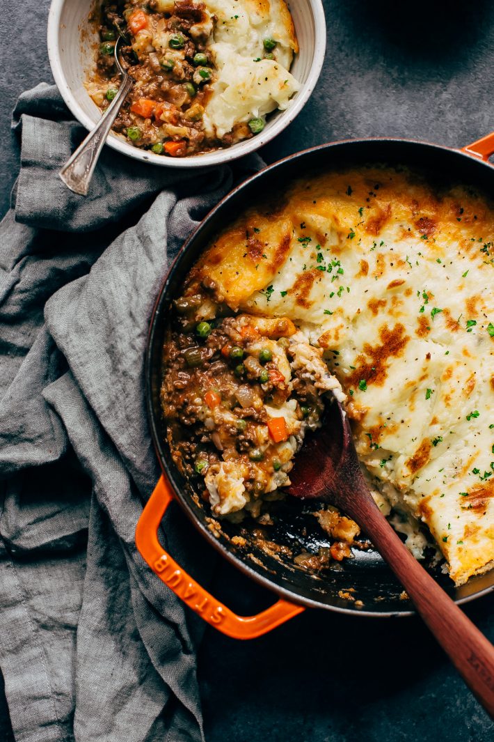 shepherd's pie in cast iron with spoon and bowlful