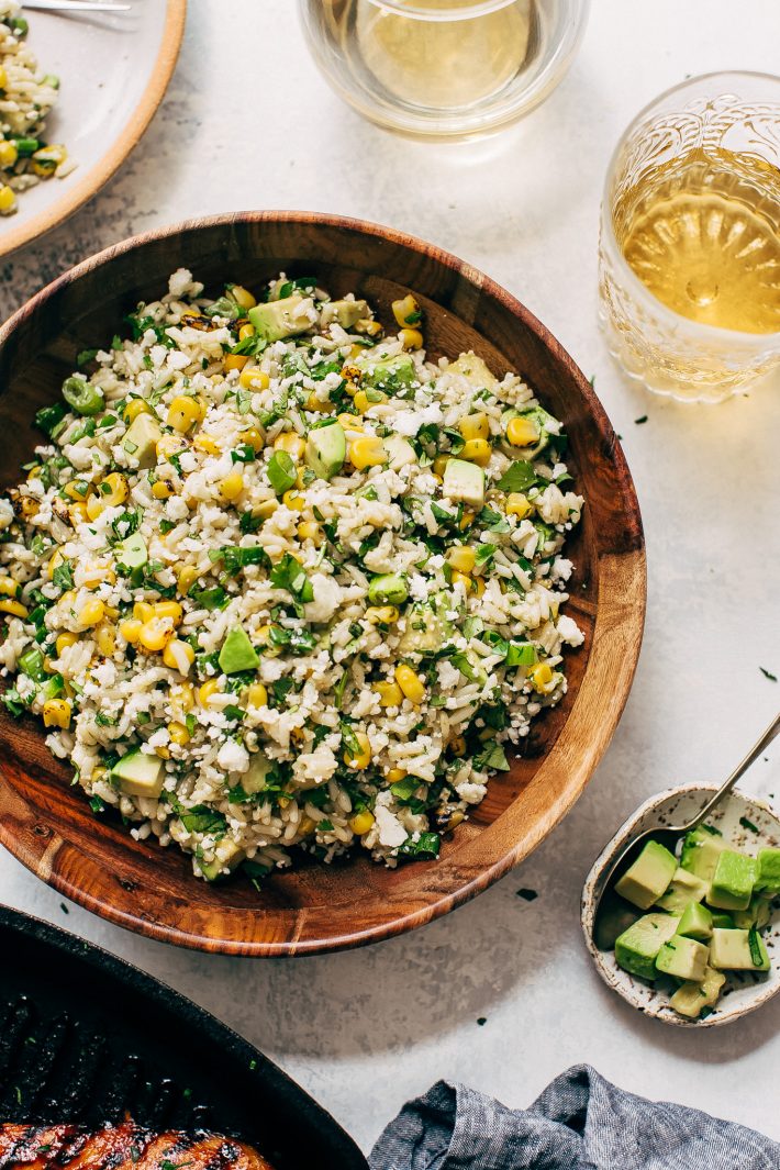 Street Corn Rice Salad with Avocados - the easiest salad you can take to a picnic or barbecue party this summer! My corn salad uses leftover cooked rice and is loaded with an easy to make lemon lime dressing! #streetcornsalad #mexicanstreetcorn #elotessalad #cornricesalad #elotes | Littlespicejar.com