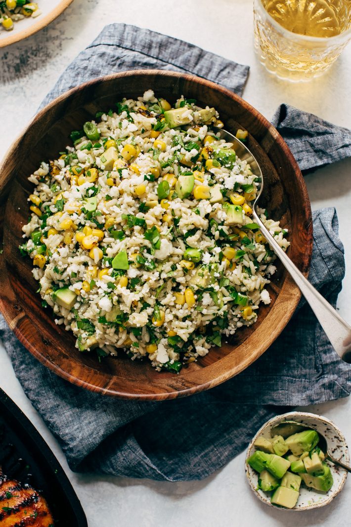 Street Corn Rice Salad with Avocados - the easiest salad you can take to a picnic or barbecue party this summer! My corn salad uses leftover cooked rice and is loaded with an easy to make lemon lime dressing! #streetcornsalad #mexicanstreetcorn #elotessalad #cornricesalad #elotes | Littlespicejar.com