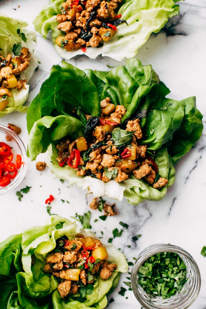 Springtime Basil Chicken Lettuce Wraps - basil chicken stuffed in lettuce wraps with garlic, red chilies, and sweet pineapple to tame that heat! The perfect protein-packed, low carb meal! #lettucewraps #thaibasilchicken #basilchicken #chickenlettucewraps | Littlespicejar.com