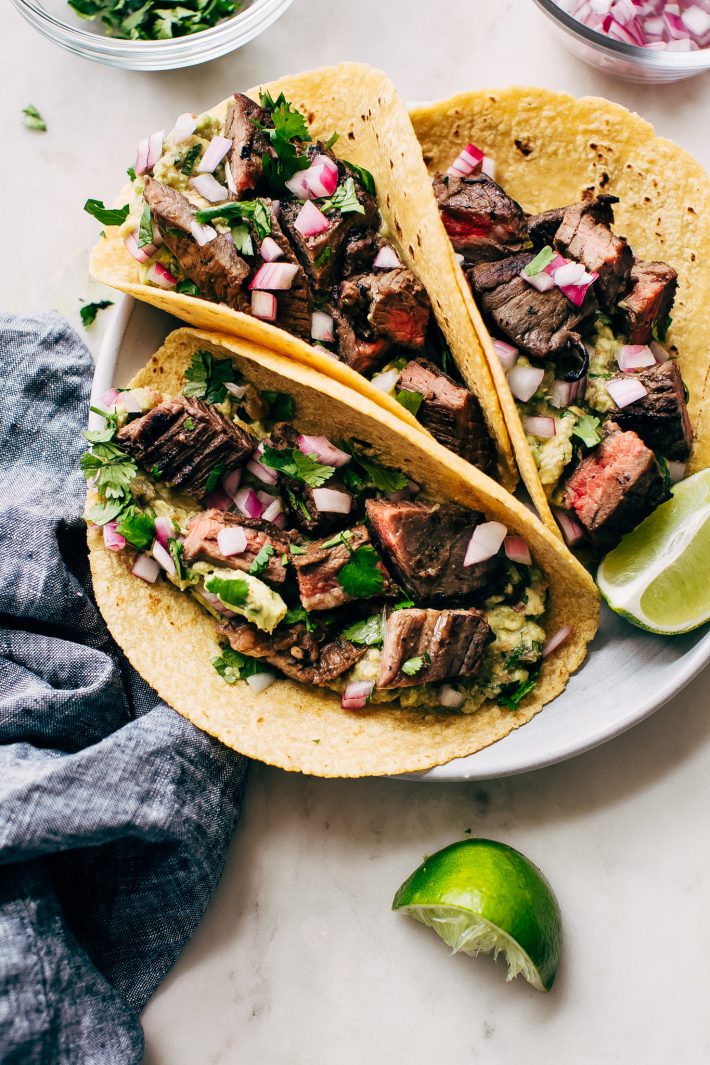 Marinated Mojo Steak Tacos with Quick Guac - Learn how to make the most tender mojo marinated steak tacos with just a few simple ingredients! #cincodemayo #steaktacos #tacos #beeftacos #steakmarinade | Littlespicejar.com
