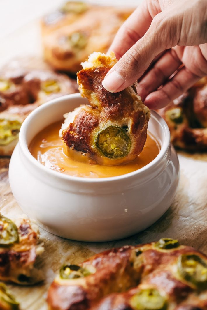 Cheddar Jalapeño Soft Pretzels - made with simple ingredients and loaded with tamed jalapeños and tons of cheddar cheese on top! So good you'll crave them ALL THE TIME! #softpretzels #jalapeñopretzels #jalapenosoftpretzels #softpretzelrecipe | Littlespicejar.com