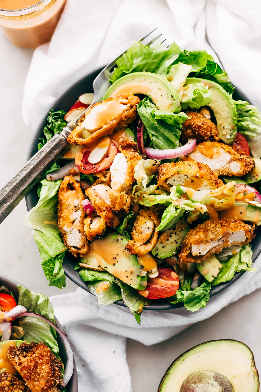 plate with strips of crispy chicken on a bed of salad