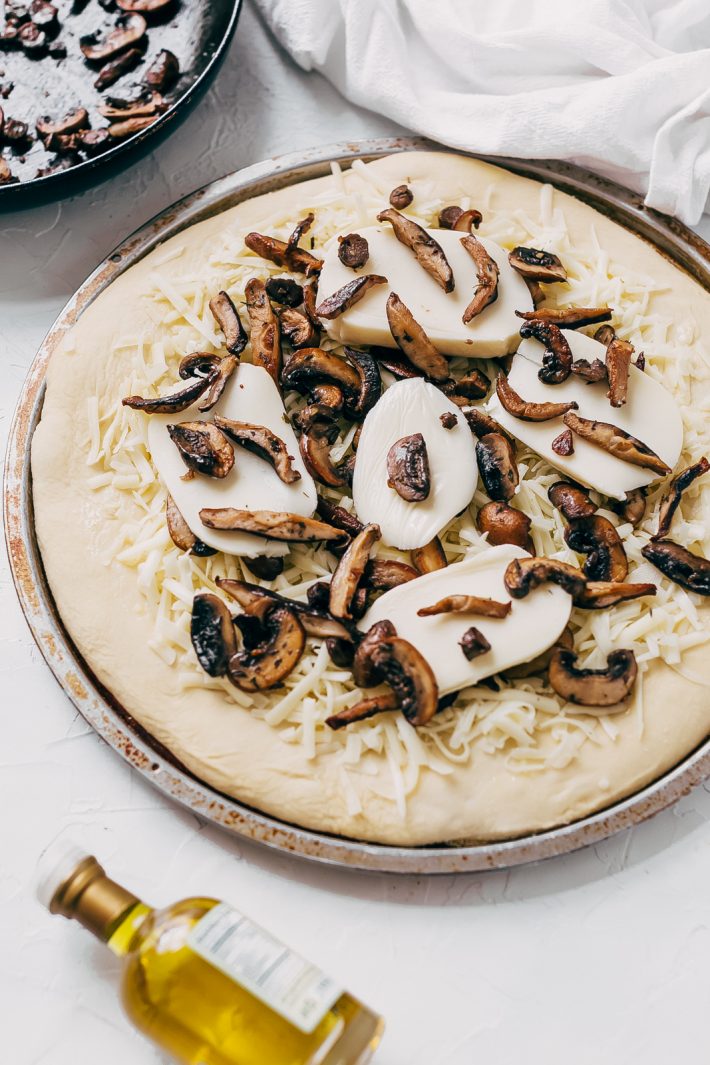 Truffled Mushroom Pizza - learn how to make a quick and easy truffled mushroom pizza! Topped with two kinds of cheese and it tastes like you ordered in from a fancy pizza shop! #pizzarecipe #mushroompizza #truffledmushroompizza #pizza | Littlespicejar.com