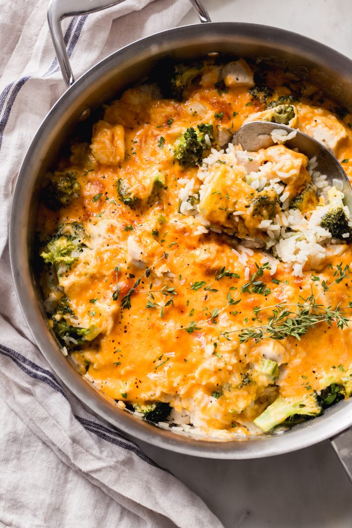 stainless steel pot with prepared chicken broccoli rice casserole with steel spoon