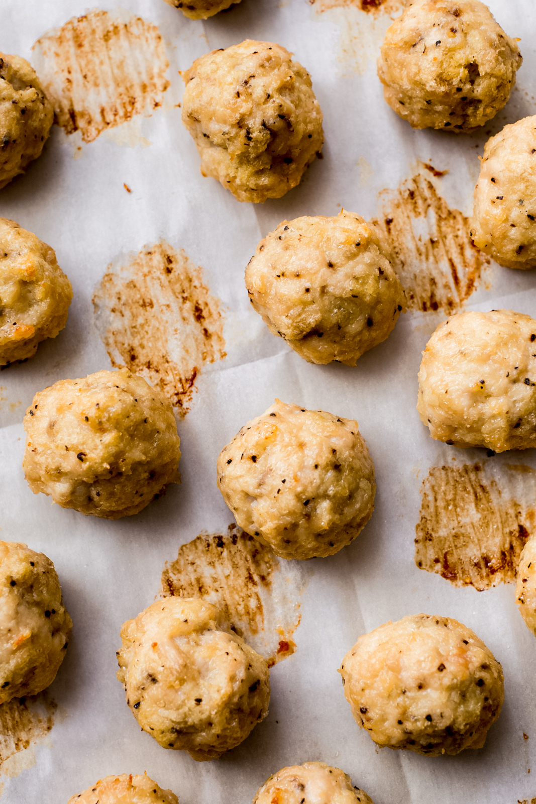 baked chicken meatballs on parchment paper