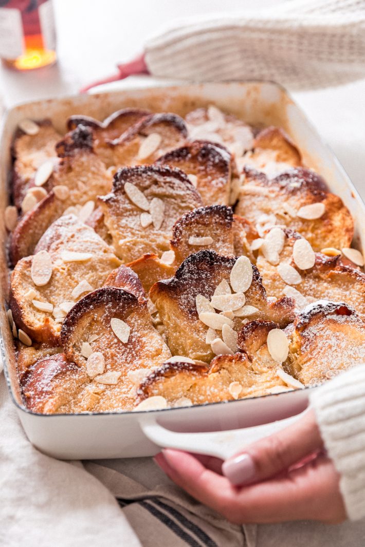 sweltered person carrying prepared creme brûlée French toast casserole