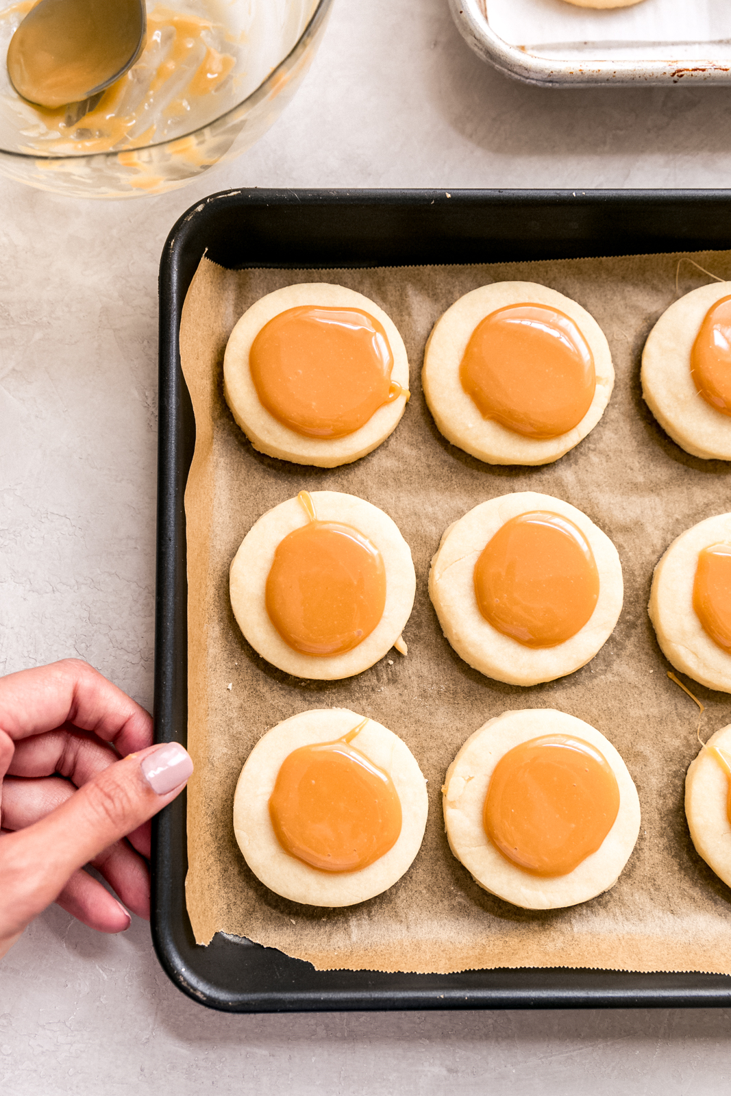 baked shortbread cookies topped with dollops of melted caramel