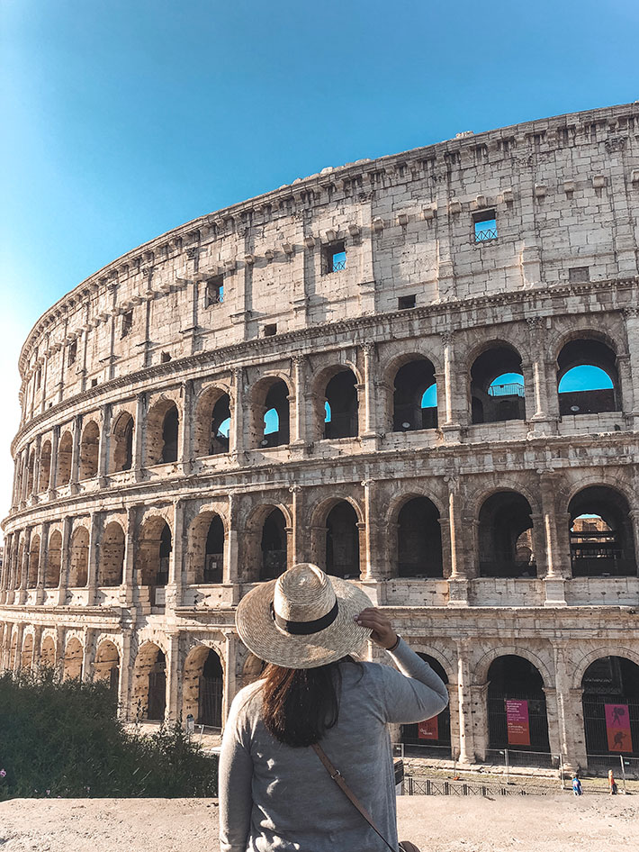 Girl standing in front of the Colosseum