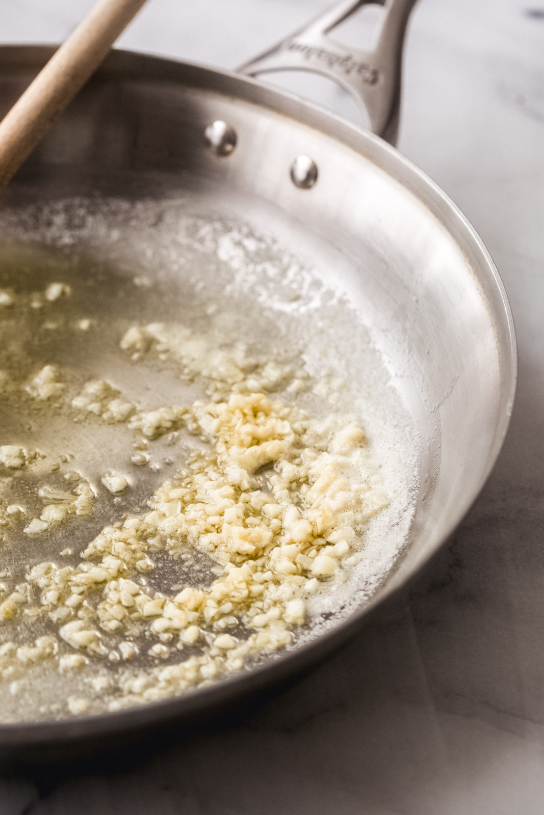 sautéing garlic in stainless steel pan