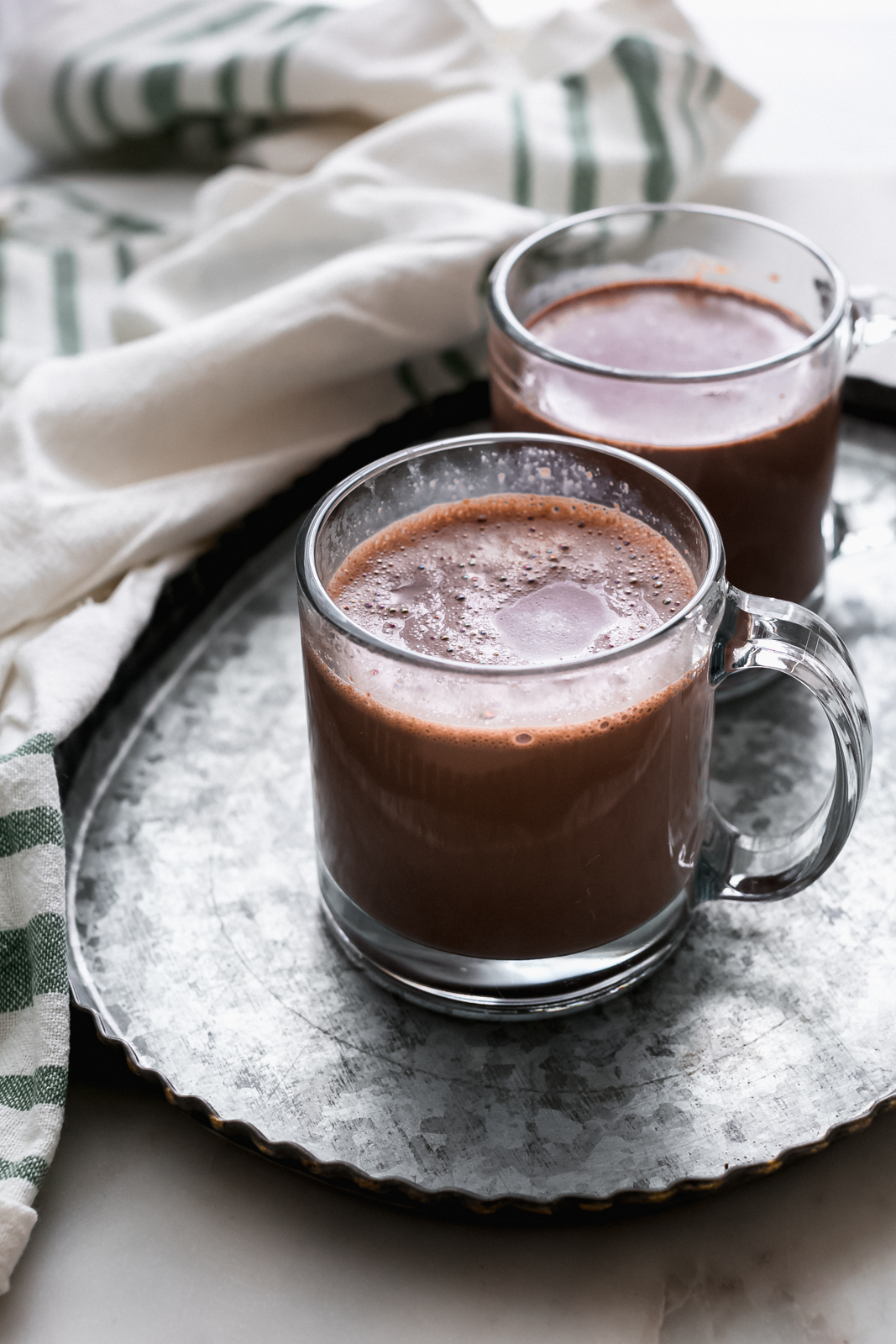 galvanized tray holding two mugs of hot chocolate