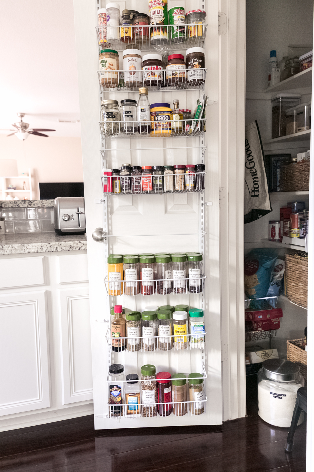 door organizer holding containers of spices with green lids