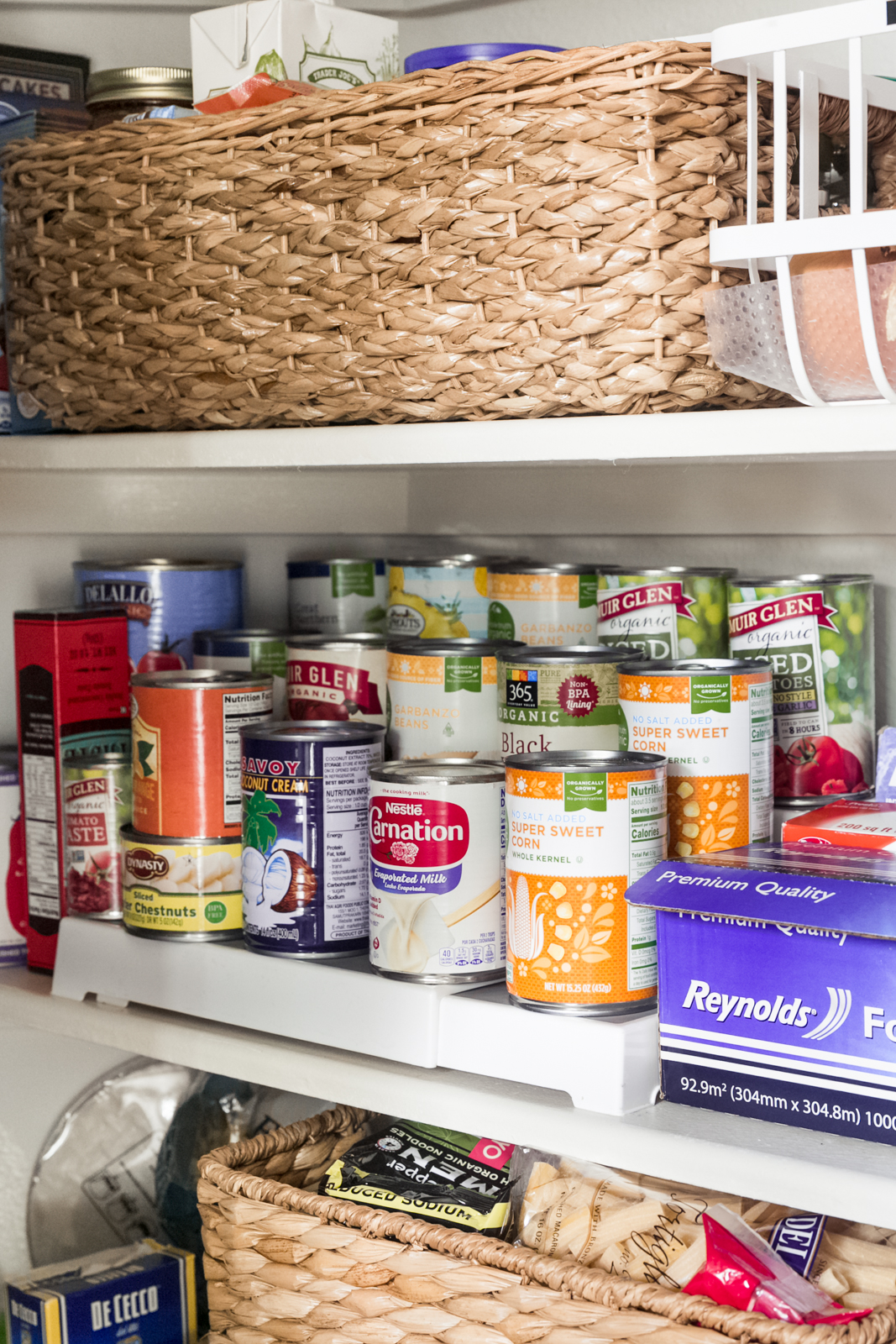 pantry shot of step organizer holding canned goods