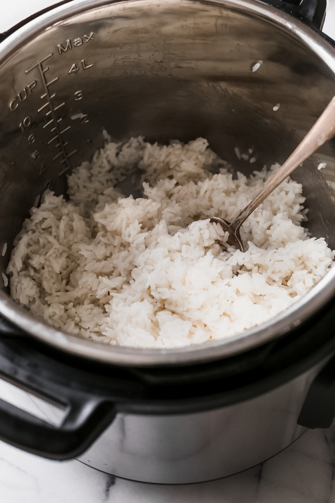 fluffing rice with spoon in instant pot