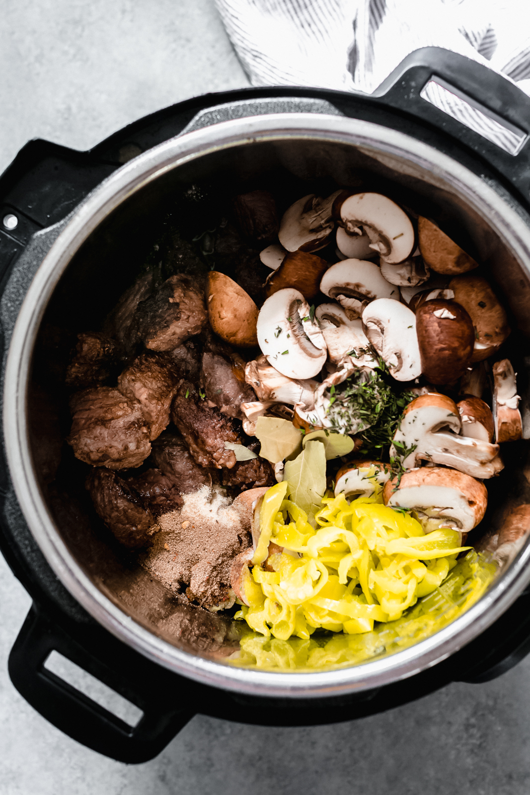 instant pot holding all the ingredients for beef tips before cooking