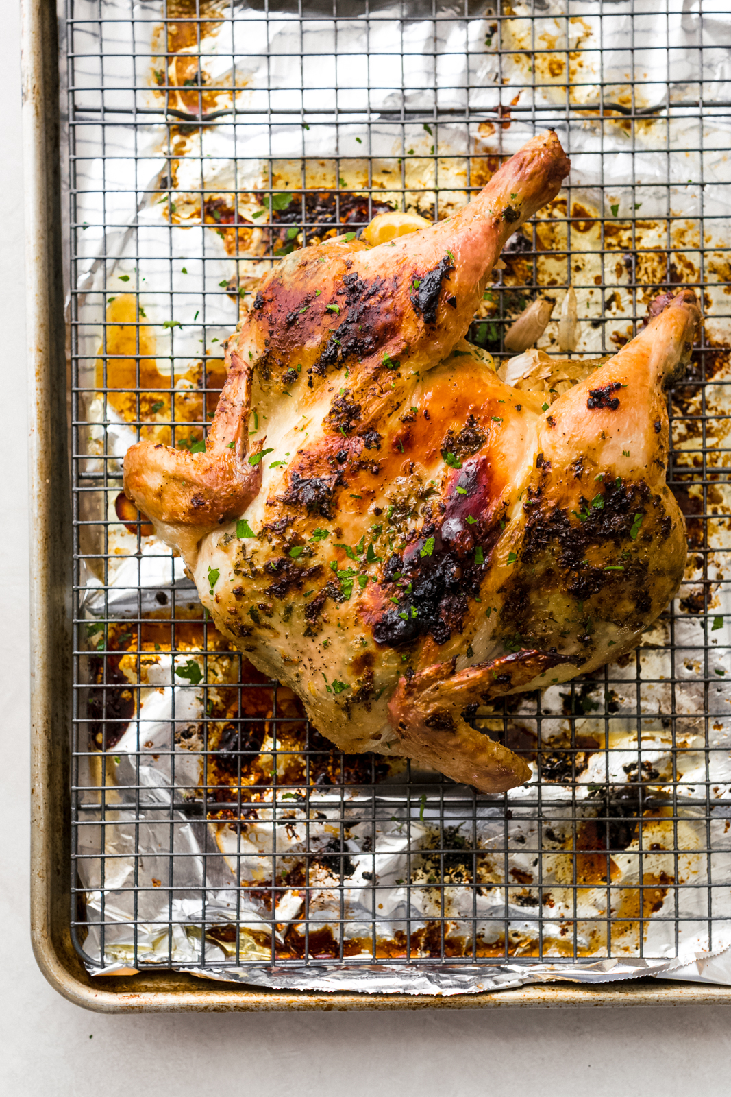 roasted chicken on sheet pan lined with foil and wire rack