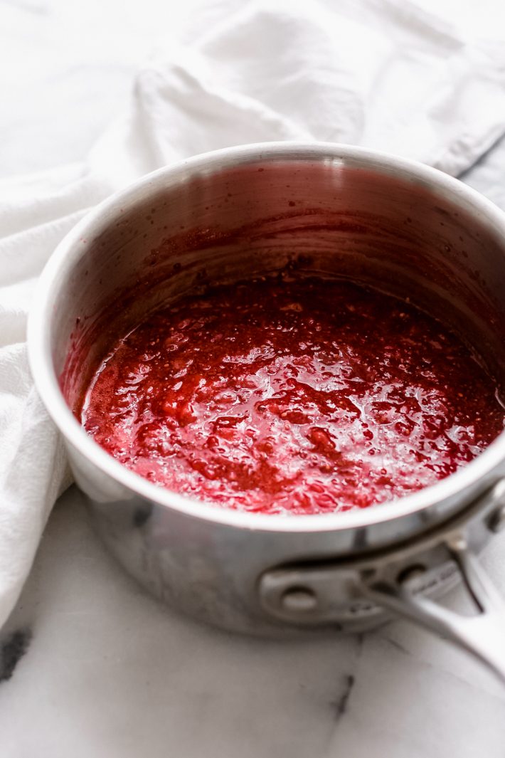 strawberry chia seeds jam in sauce pot on white marble