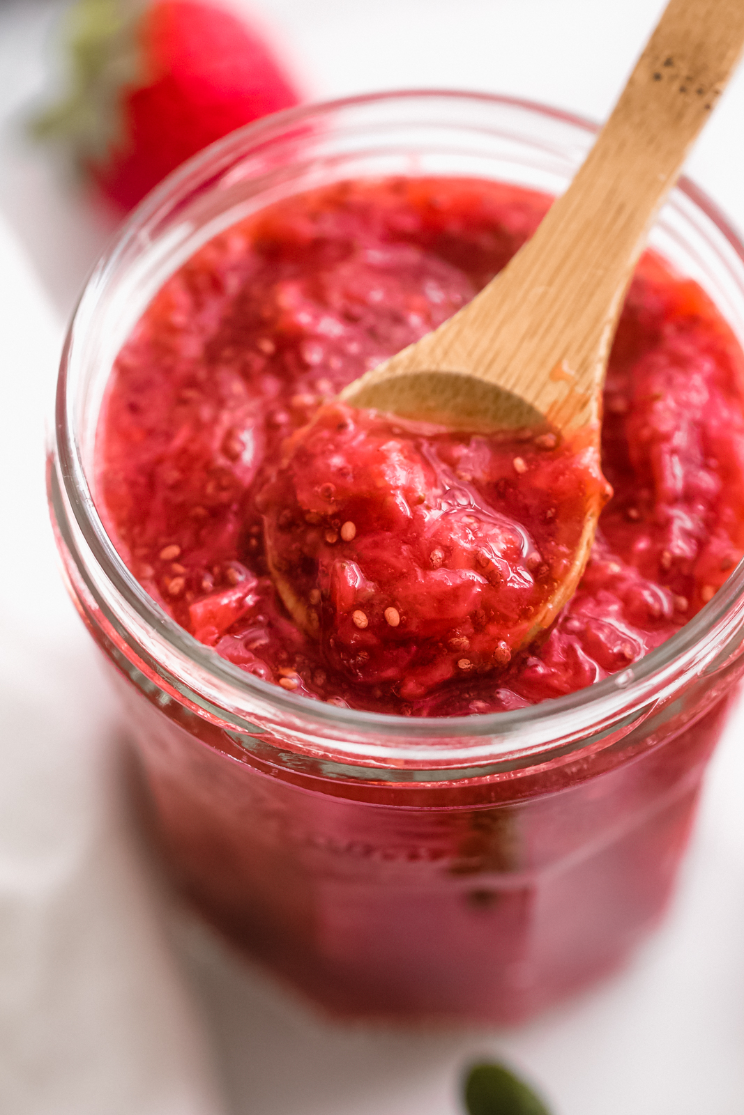 chia seed jam in jar with a spoon resting on the top