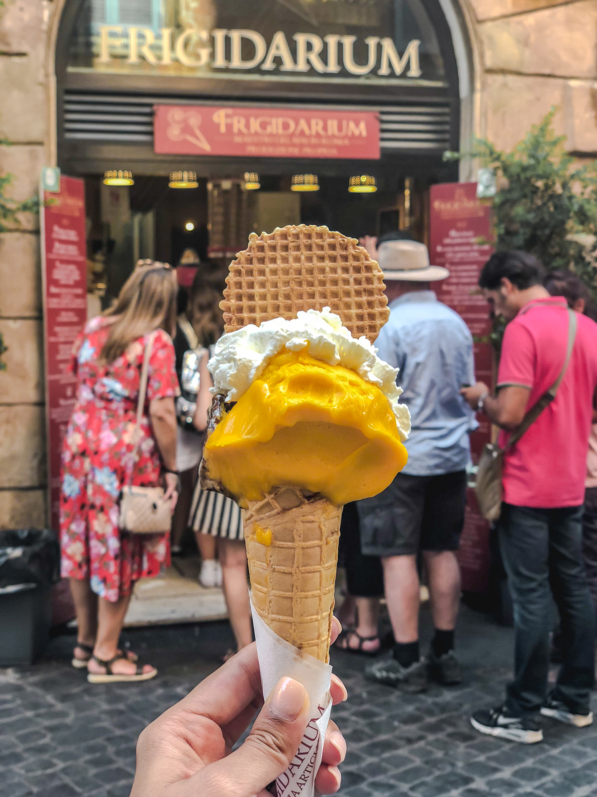 mango gelato on a cone from frigidarium