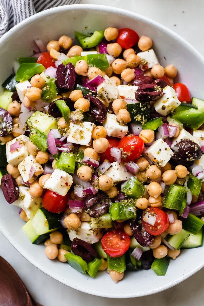clos dup of greek olives, feta cheese, bell peppers, chickpeas, and lemon dressing