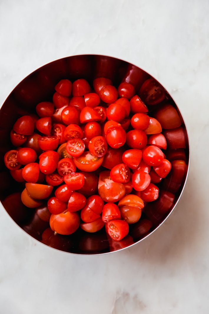 metal bowl holding grape tomato halves