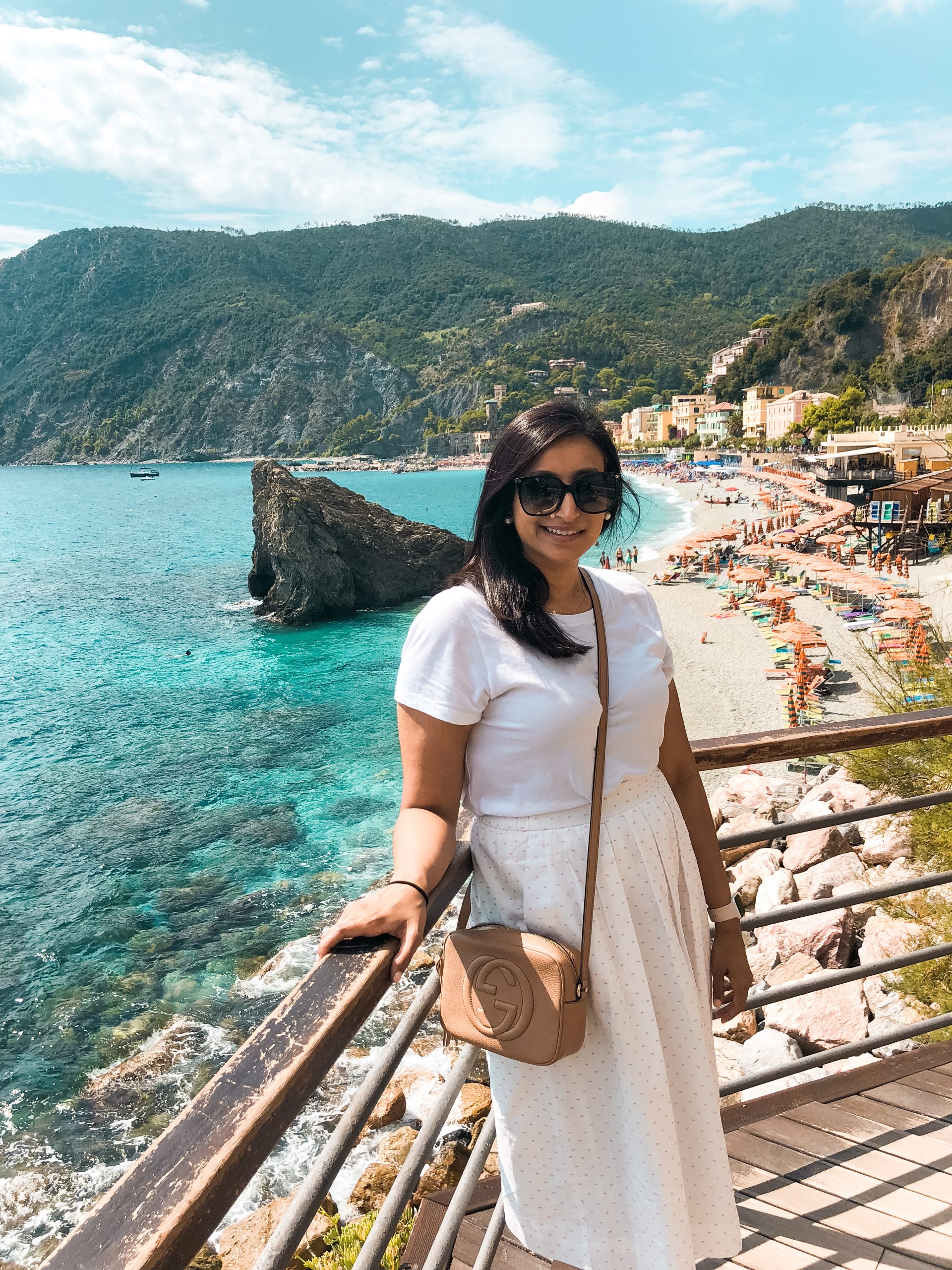me standing with the aqua water of Monterosso al Mar behind me 