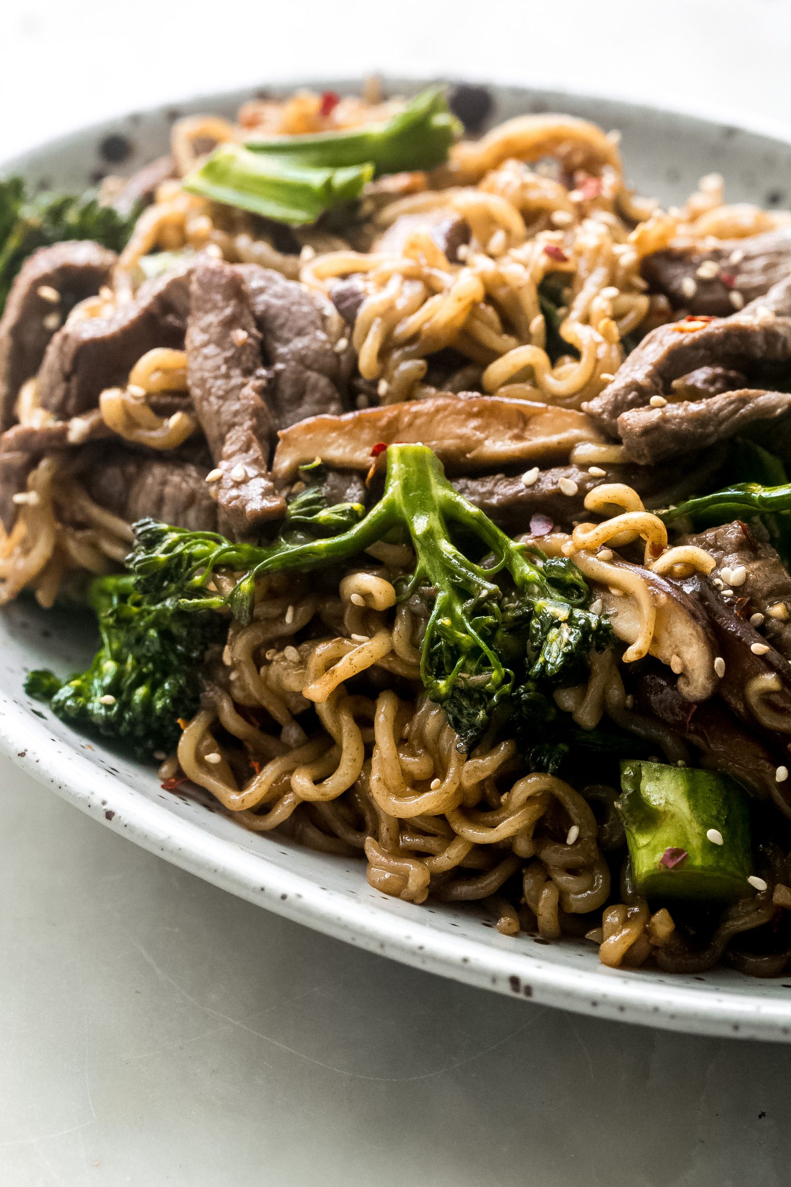 side shot of ramen noodles with beef and broccoli