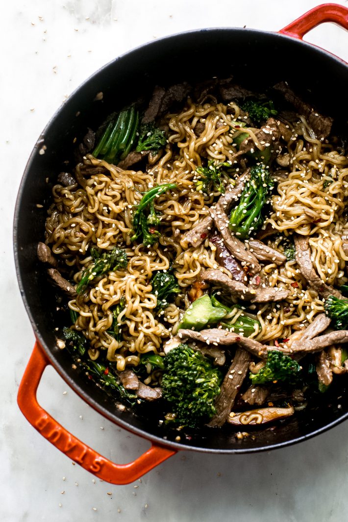 cast iron pot with ramen noodles with broccolini and sautéed beef