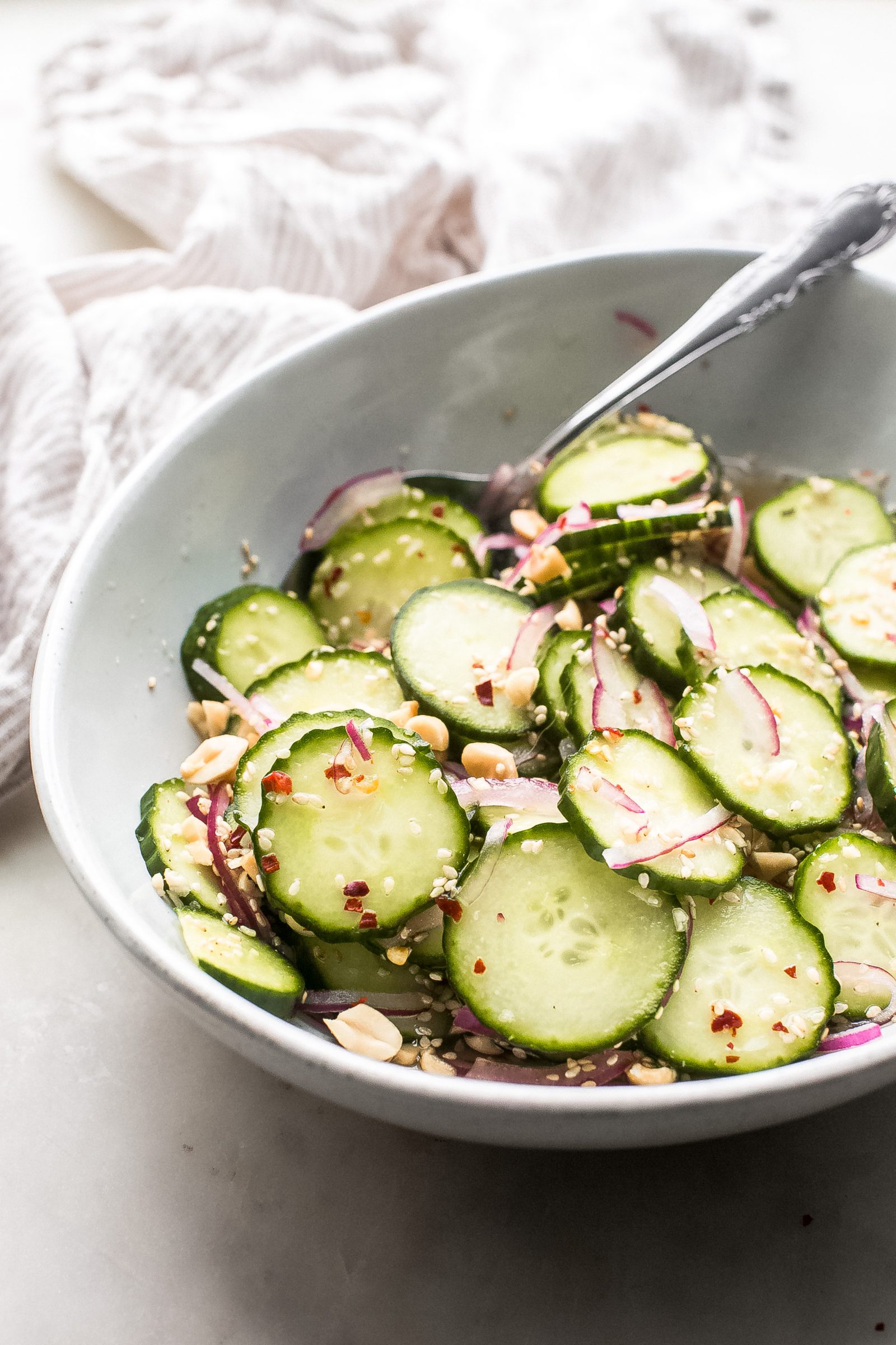 white oval bowl with pickled Thai cucumber salad 