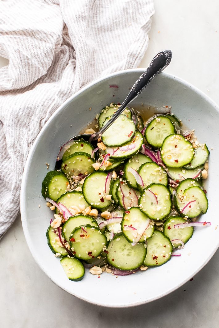 bowl with cucumber salad with red onions and sesame seeds