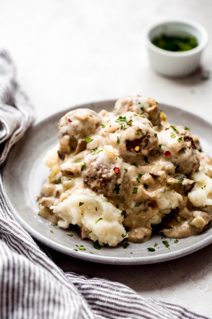plate of prepared cheesesteak meatballs on a bed of mashed potatoes