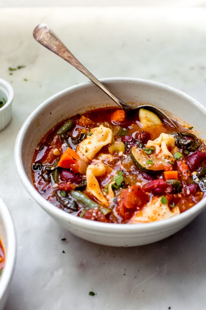 Fire-roasted Tortellini Minestrone Soup - a quick and hearty take on the traditional minestrone. Mine is a stove-top version that uses tortellini instead of pasta. Great for boxed lunches or as a starter to dinner guests! #minestronesoup #tortellini #tortelliniminestrone #minstrone #vegetablesoup | Littlespicejar.com