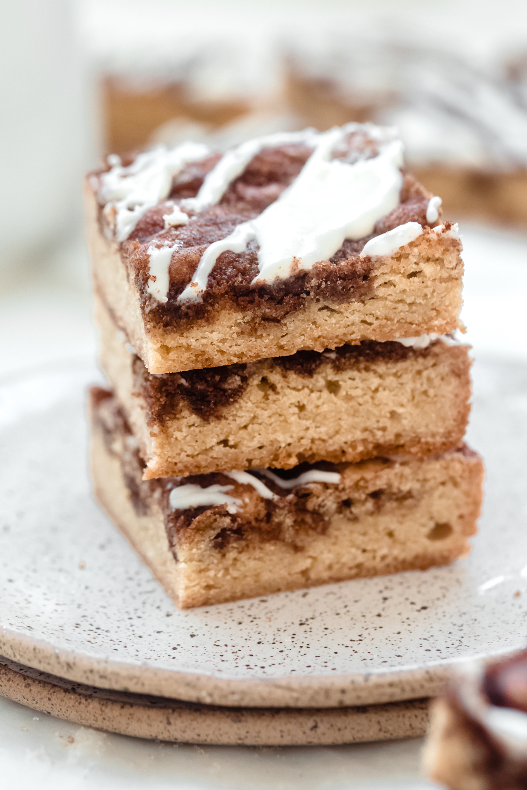 stack on blondies on stack of plated topped with icing