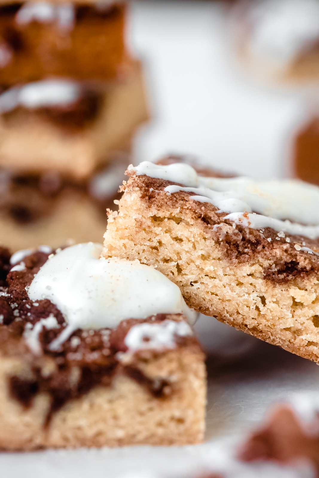 close up of texture of cinnamon roll blondies with icing