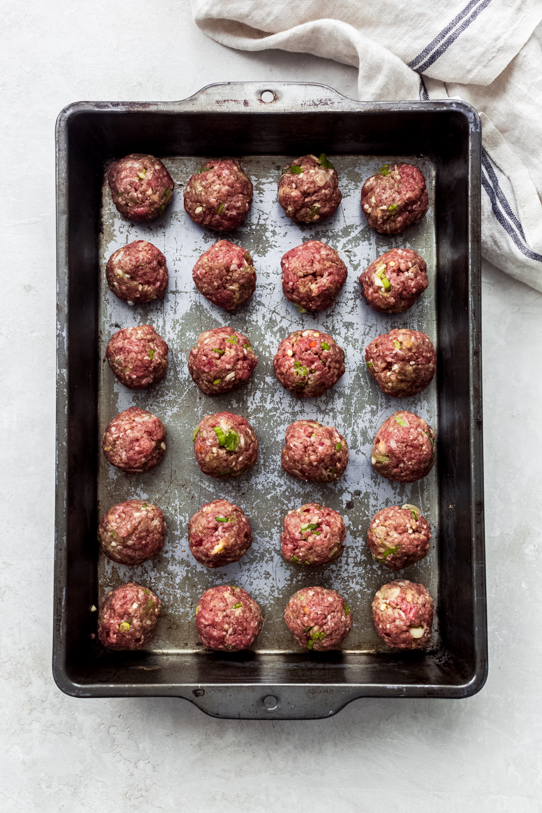 prepared meatballs on a baking dish ready to bake