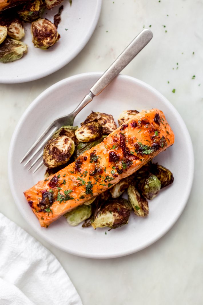 baked salmon on a plate with roasted Brussel sprouts