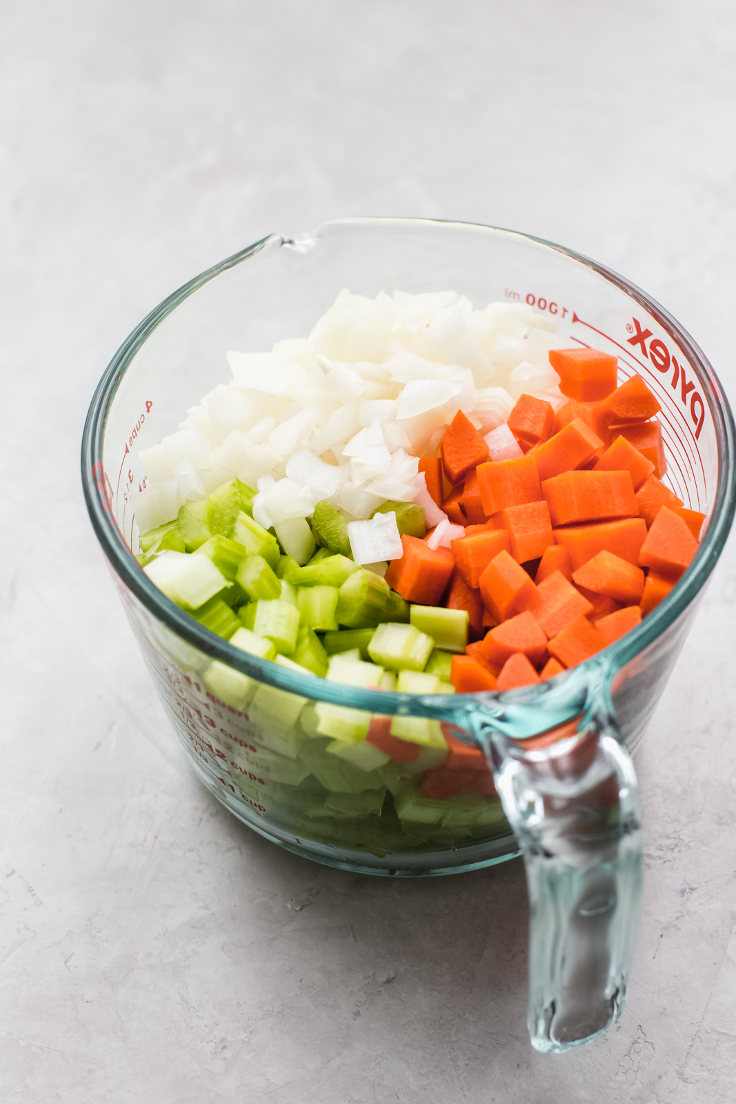 measuring cup with chopped veggies for the soup