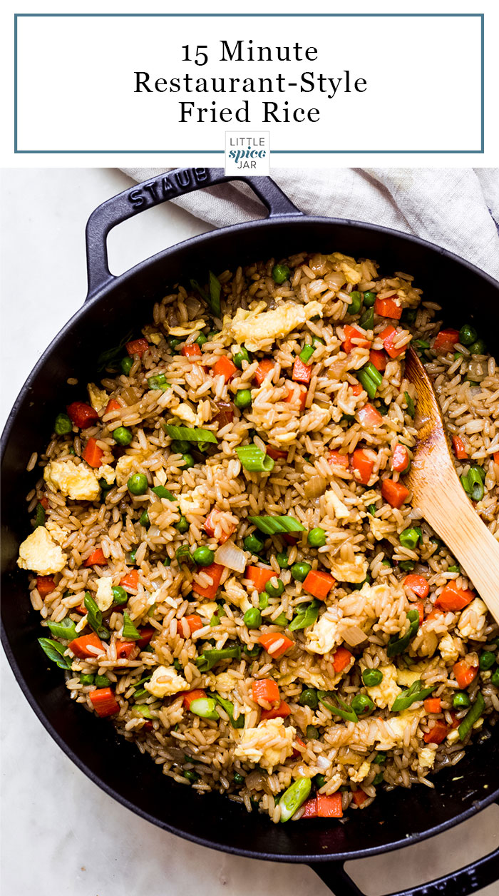 prepared fried rice in a cast iron pot with wooden spoon