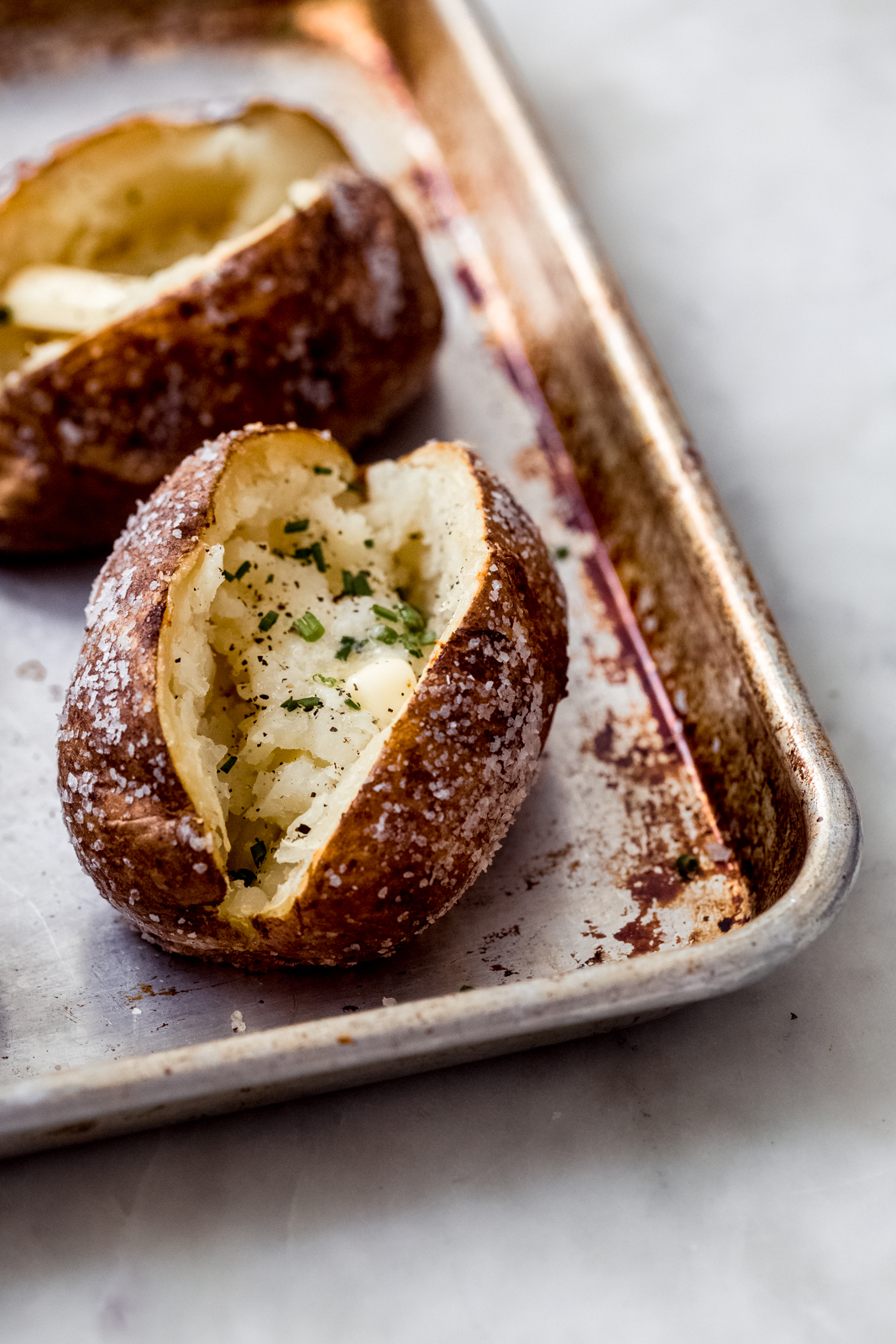 Salty, crispy perfect baked potatoes on a sheet pan
