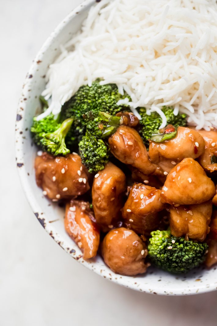 close up of teriyaki chicken in a bowl with broccoli and rice