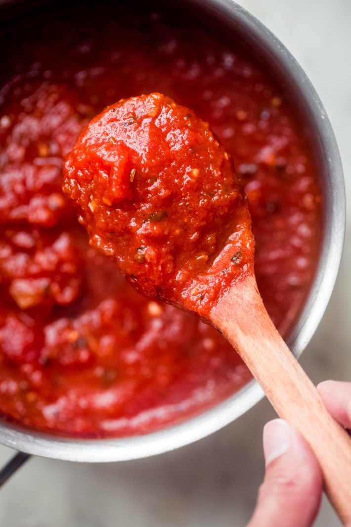 close up of freshly made pizza sauce on spoon