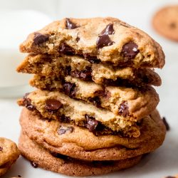 stick of chocolate chip cookies with broken halves showing inside texture on marble