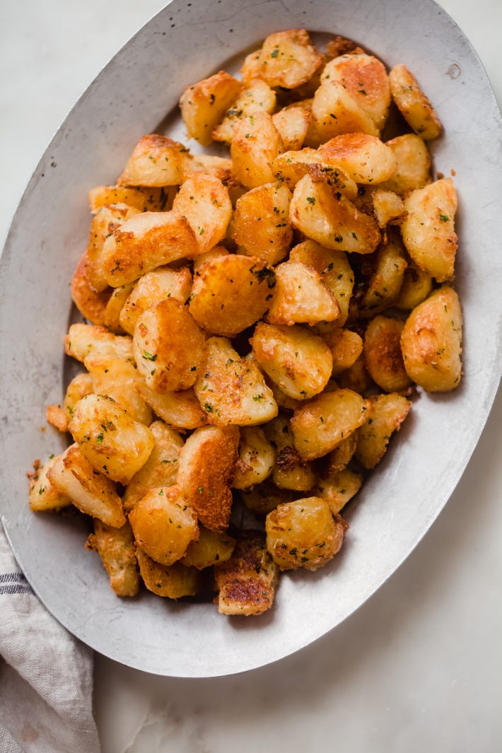 crispy roasted potatoes on a metal plate